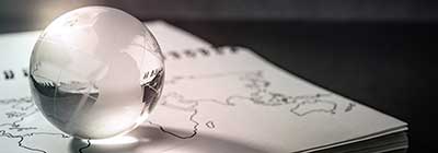 Glass globe resting on a drawing of a map